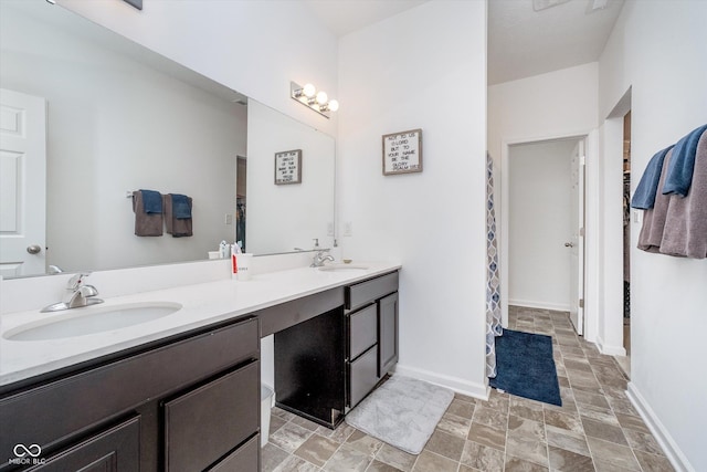 5304 Maywood Dr, Whitestown, IN 46075 - full bath featuring double vanity, stone finish flooring, and baseboards