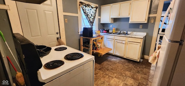 315 S Rural St, Indianapolis, IN 46201 - kitchen with light countertops, a sink, white appliances, dark stone finish floors, and white cabinets