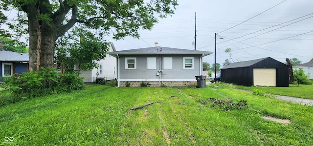315 S Rural St, Indianapolis, IN 46201 - back of house featuring a garage and an outdoor structure