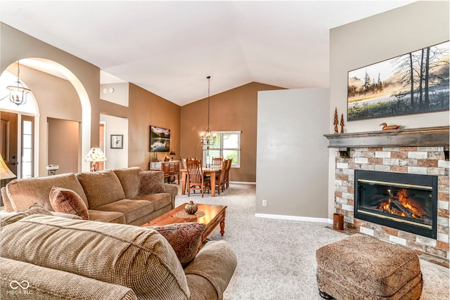 10759 Sawgrass Dr, Fishers, IN 46037 - living room featuring a chandelier, carpet floors, a stone fireplace, high vaulted ceiling, and arched walkways