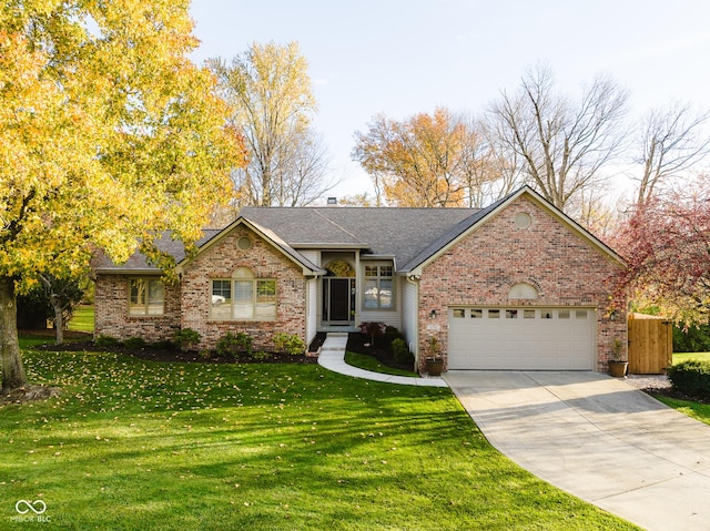 10759 Sawgrass Dr, Fishers, IN 46037 - ranch-style house with brick siding, an attached garage, concrete driveway, a front lawn, and roof with shingles