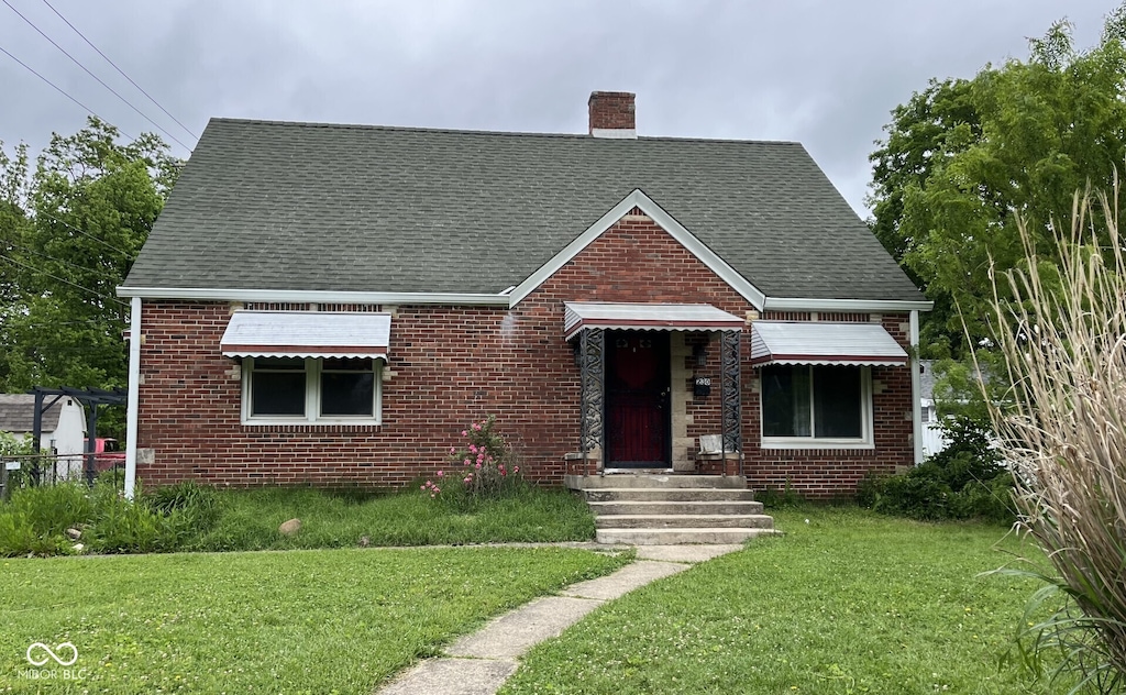 230 E Poplar St, Danville, IN 46122 - view of front of property featuring brick siding, a front lawn, and a chimney