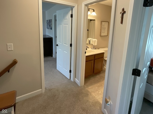425 Bridgewater Ln S, Muncie, IN 47304 - corridor with light colored carpet, a sink, baseboards, and an upstairs landing