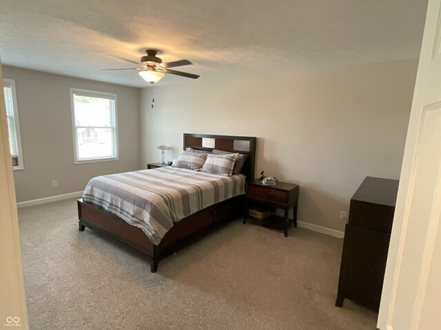 425 Bridgewater Ln S, Muncie, IN 47304 - bedroom featuring baseboards, light colored carpet, and a ceiling fan