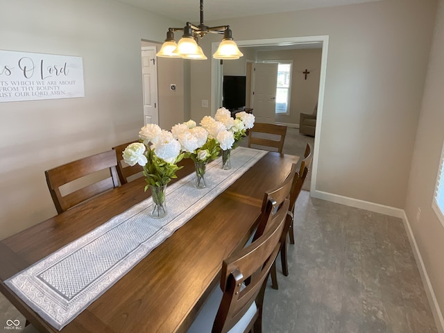 425 Bridgewater Ln S, Muncie, IN 47304 - dining area featuring baseboards, a chandelier, and wood finished floors