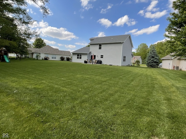 425 Bridgewater Ln S, Muncie, IN 47304 - back of property featuring a lawn, cooling unit, and a playground