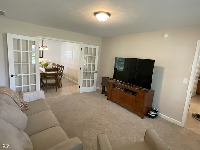 425 Bridgewater Ln S, Muncie, IN 47304 - living area featuring french doors, light colored carpet, and baseboards