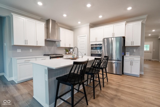 9741 Haughton Ln, Mccordsville, IN 46055 - kitchen featuring appliances with stainless steel finishes, wall chimney range hood, crown molding, tasteful backsplash, and a breakfast bar