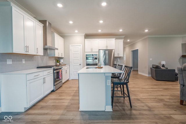 9741 Haughton Ln, Mccordsville, IN 46055 - kitchen featuring appliances with stainless steel finishes, ornamental molding, wall chimney range hood, recessed lighting, and a kitchen bar