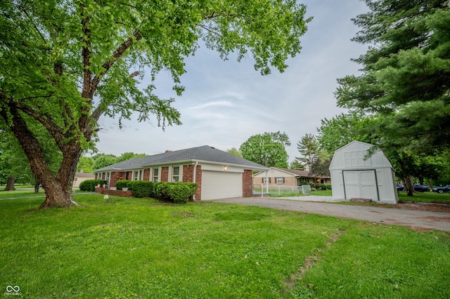 3457 W 58th St, Indianapolis, IN 46228 - view of front facade with a front yard, asphalt driveway, brick siding, and a garage