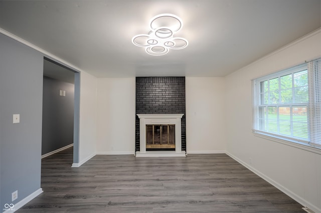 3457 W 58th St, Indianapolis, IN 46228 - unfurnished living room featuring a fireplace, wood finished floors, ornamental molding, and baseboards