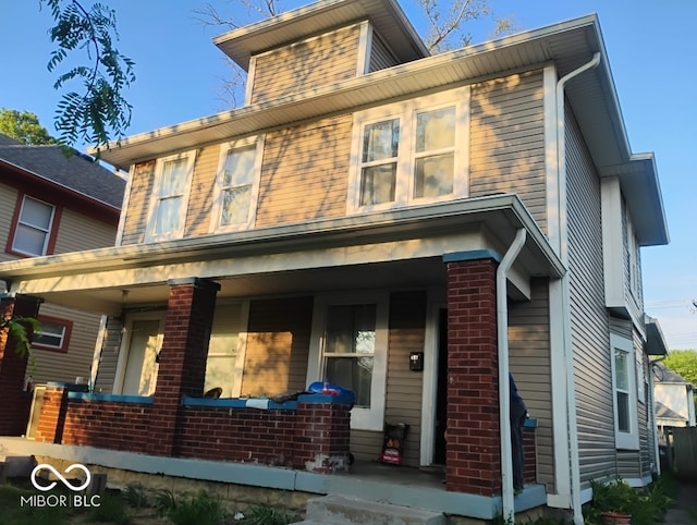 639 N Hamilton Ave, Indianapolis, IN 46201 - view of front facade featuring covered porch and brick siding
