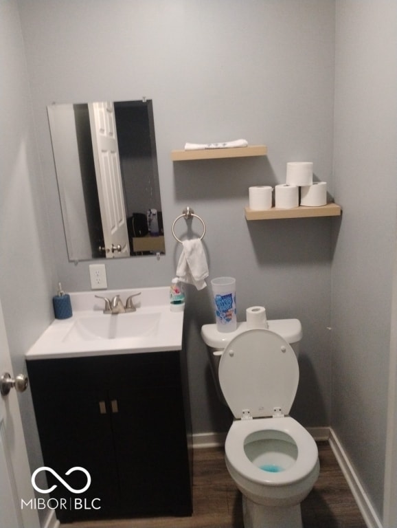 639 N Hamilton Ave, Indianapolis, IN 46201 - half bath with wood finished floors, vanity, baseboards, and toilet
