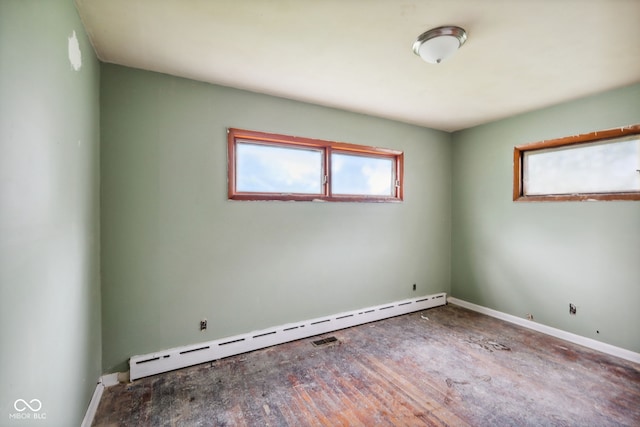 1514 W 2nd St, Marion, IN 46952 - spare room featuring a baseboard heating unit, baseboards, and wood finished floors