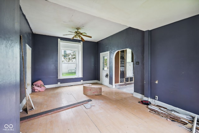 1514 W 2nd St, Marion, IN 46952 - exercise room featuring arched walkways, a ceiling fan, hardwood / wood-style floors, and baseboards