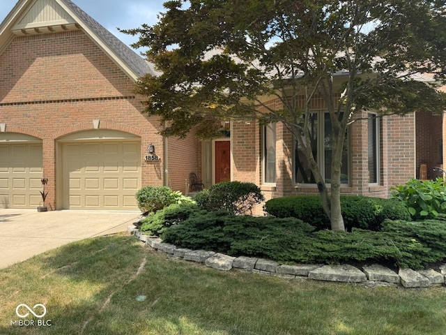 1858 Broadleaf Ct, Greenwood, IN 46143 - view of front facade featuring driveway, brick siding, and a garage