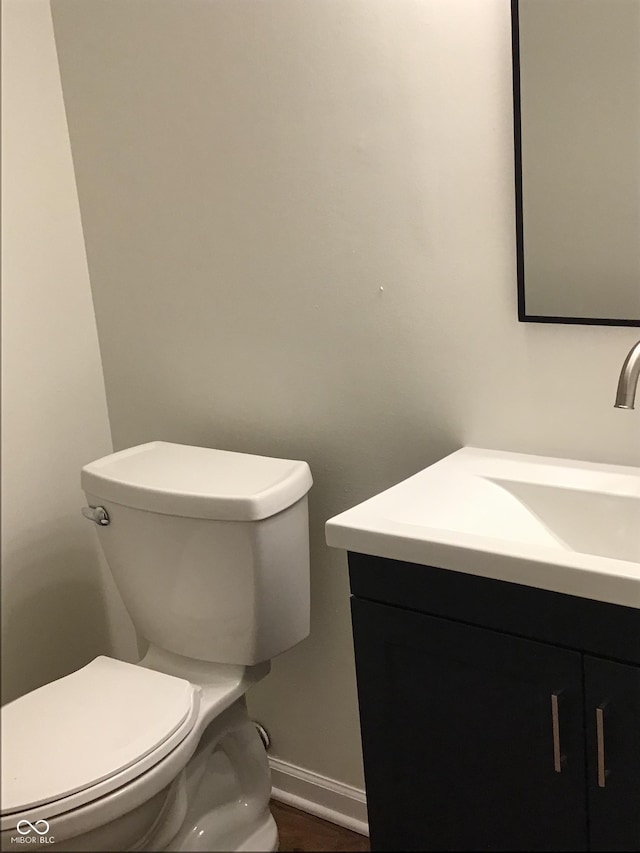 6070 Southbay Dr, Indianapolis, IN 46250 - bathroom featuring vanity, toilet, baseboards, and wood finished floors