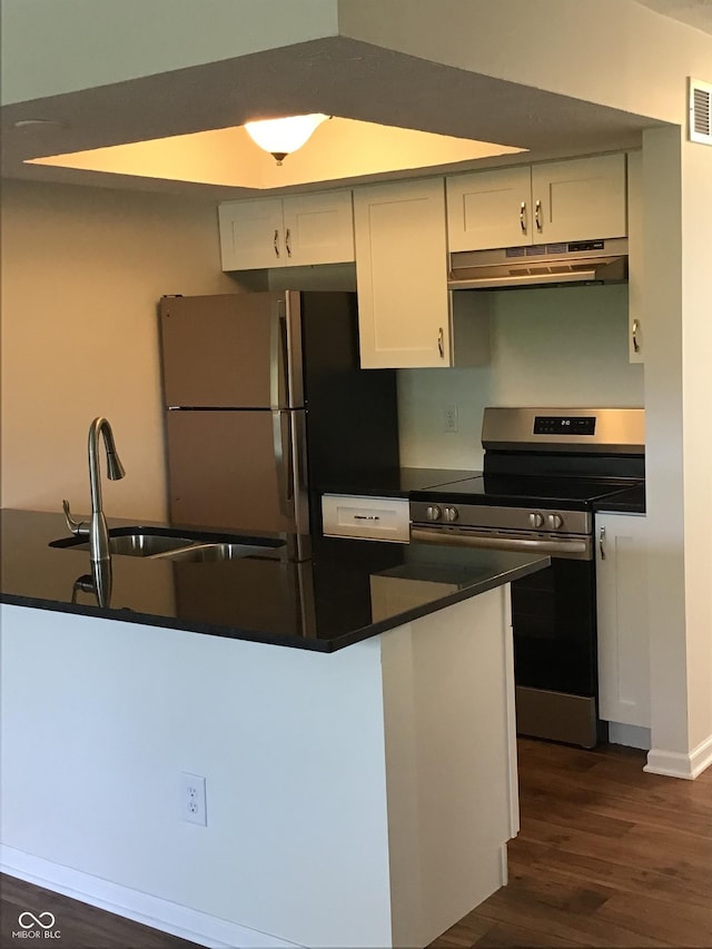 6070 Southbay Dr, Indianapolis, IN 46250 - kitchen featuring stainless steel electric stove, under cabinet range hood, freestanding refrigerator, and dark countertops