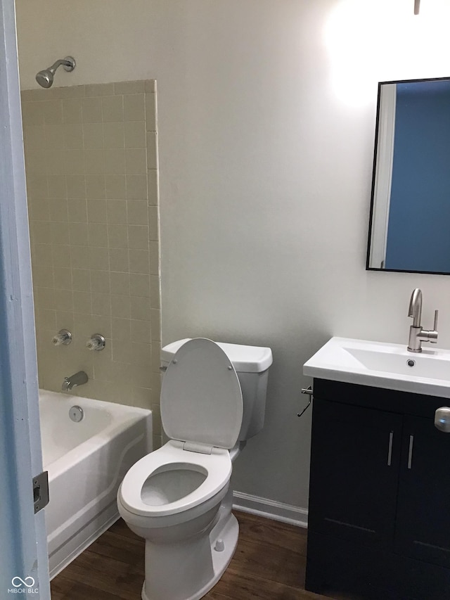 6070 Southbay Dr, Indianapolis, IN 46250 - bathroom with toilet, vanity, wood finished floors, and bathing tub / shower combination