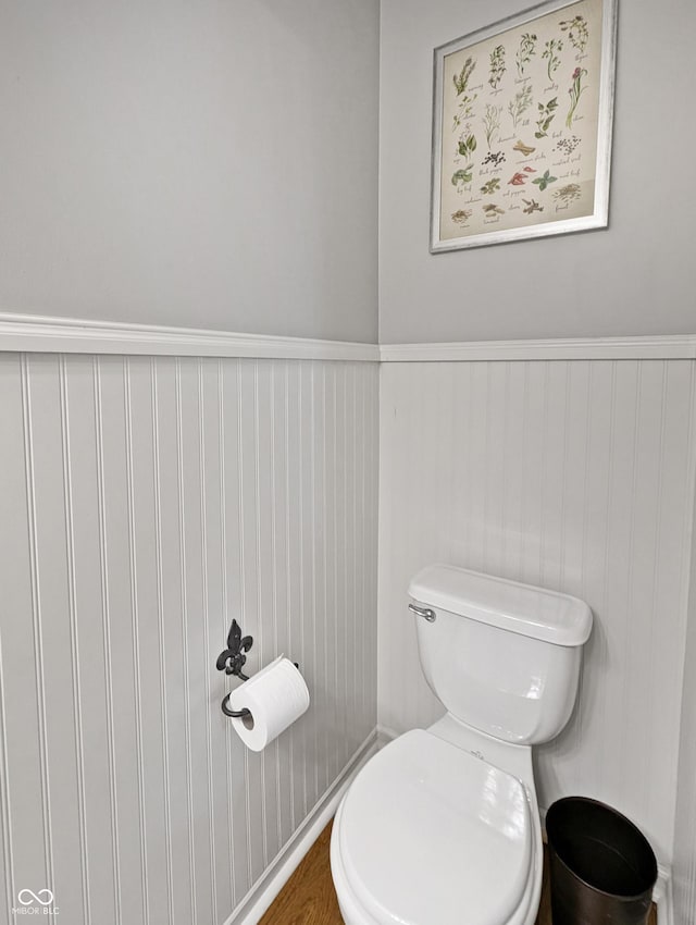 319 Mcintosh Ln, Westfield, IN 46074 - bathroom featuring toilet, a wainscoted wall, and wood finished floors