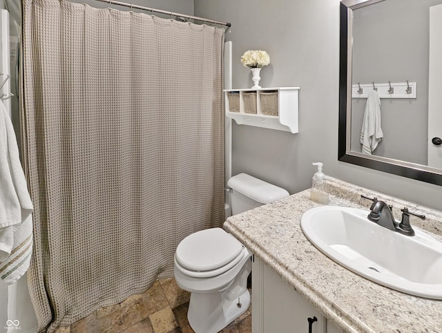 319 Mcintosh Ln, Westfield, IN 46074 - bathroom with vanity, toilet, stone finish flooring, and a shower with shower curtain