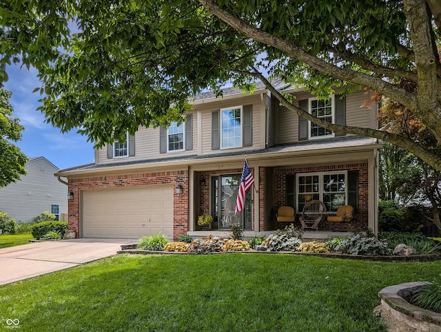 319 Mcintosh Ln, Westfield, IN 46074 - traditional-style house with covered porch, brick siding, a garage, a front yard, and driveway