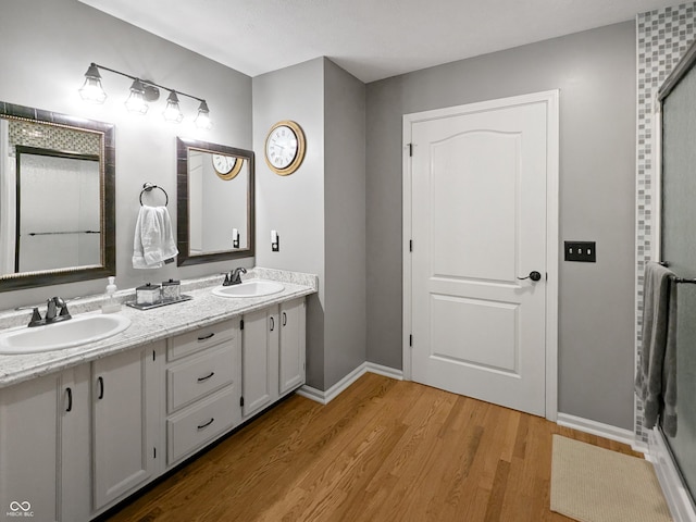 319 Mcintosh Ln, Westfield, IN 46074 - full bath with double vanity, wood finished floors, baseboards, and an enclosed shower