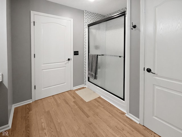 319 Mcintosh Ln, Westfield, IN 46074 - bathroom featuring wood finished floors, a stall shower, and baseboards