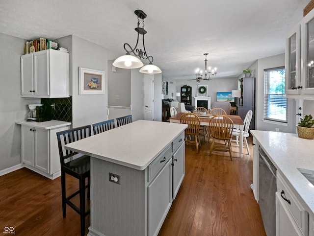 319 Mcintosh Ln, Westfield, IN 46074 - kitchen with dark wood-style flooring, a breakfast bar area, glass insert cabinets, and a chandelier