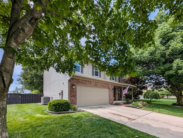 319 Mcintosh Ln, Westfield, IN 46074 - traditional-style home with central AC, brick siding, a garage, and concrete driveway