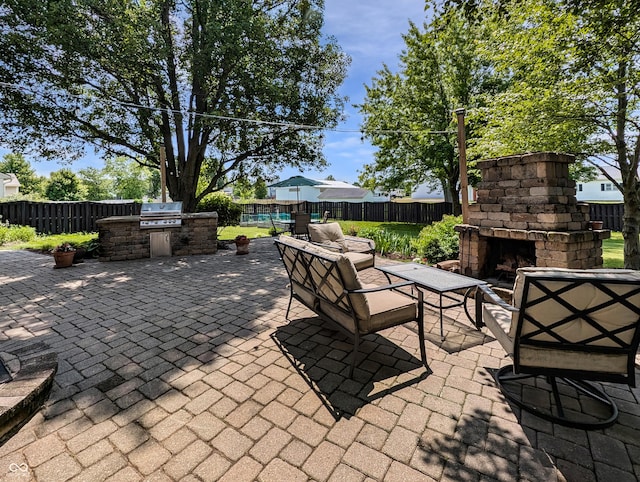 319 Mcintosh Ln, Westfield, IN 46074 - fenced backyard featuring an outdoor stone fireplace and a patio area