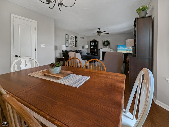 319 Mcintosh Ln, Westfield, IN 46074 - dining space featuring a chandelier, a ceiling fan, dark wood-style floors, and baseboards