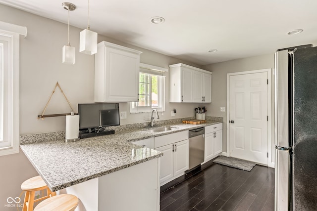 800 E 104th St, Carmel, IN 46280 - kitchen featuring stainless steel appliances, a sink, a peninsula, dark wood finished floors, and white cabinets