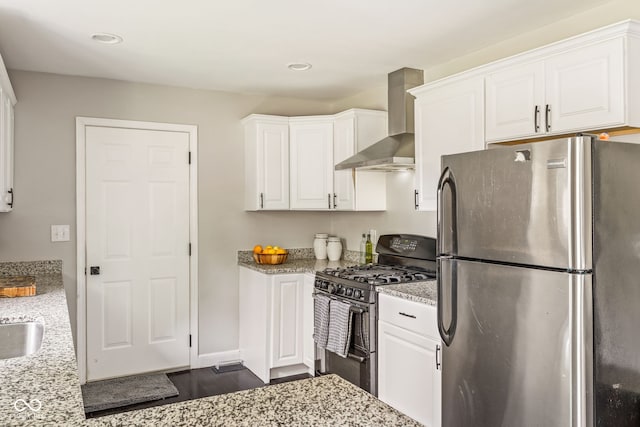 800 E 104th St, Carmel, IN 46280 - kitchen featuring freestanding refrigerator, wall chimney exhaust hood, black gas range, white cabinets, and light stone countertops