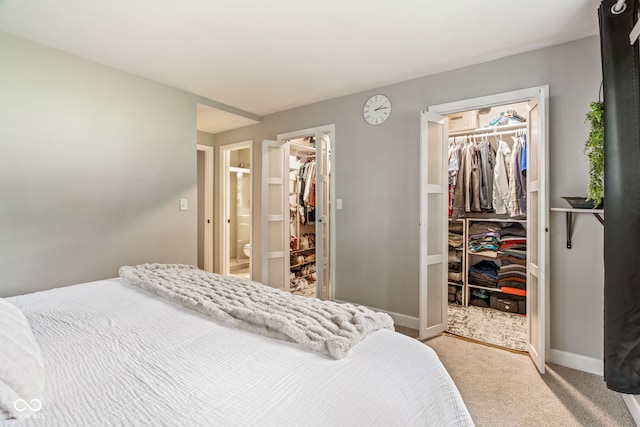 800 E 104th St, Carmel, IN 46280 - bedroom featuring a walk in closet, a closet, light colored carpet, and baseboards