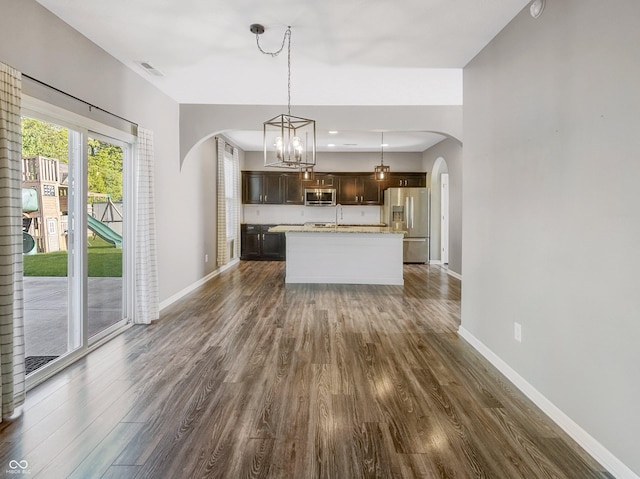 1843 Winchester Blvd, Avon, IN 46123 - kitchen featuring stainless steel appliances, arched walkways, dark brown cabinetry, and dark wood-type flooring