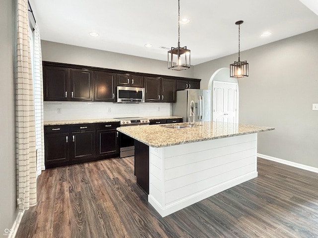 1843 Winchester Blvd, Avon, IN 46123 - kitchen with appliances with stainless steel finishes, dark wood-style flooring, a kitchen island with sink, baseboards, and a sink