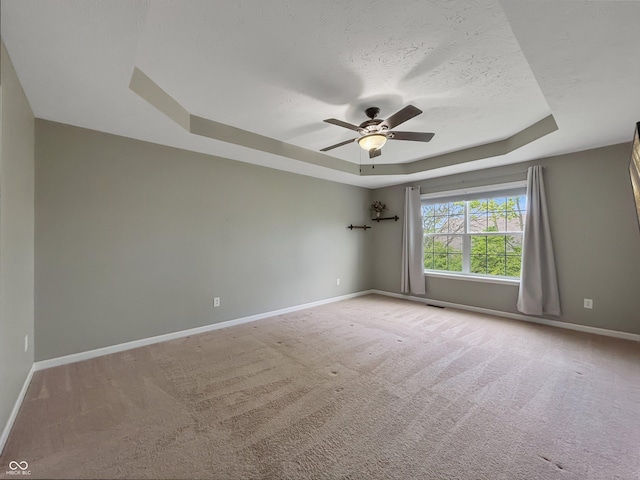 1843 Winchester Blvd, Avon, IN 46123 - spare room with a raised ceiling, baseboards, a ceiling fan, carpet flooring, and a textured ceiling