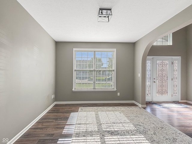1843 Winchester Blvd, Avon, IN 46123 - entryway with arched walkways, dark wood-type flooring, baseboards, and a textured ceiling