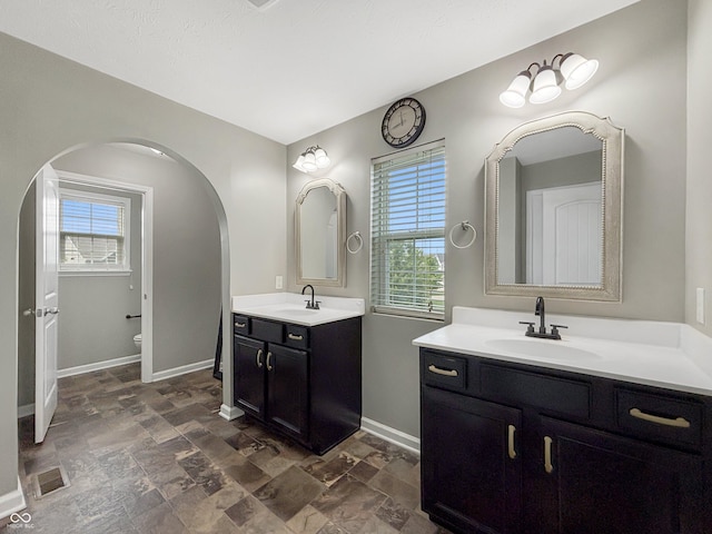 1843 Winchester Blvd, Avon, IN 46123 - full bathroom with stone finish flooring, plenty of natural light, and two vanities