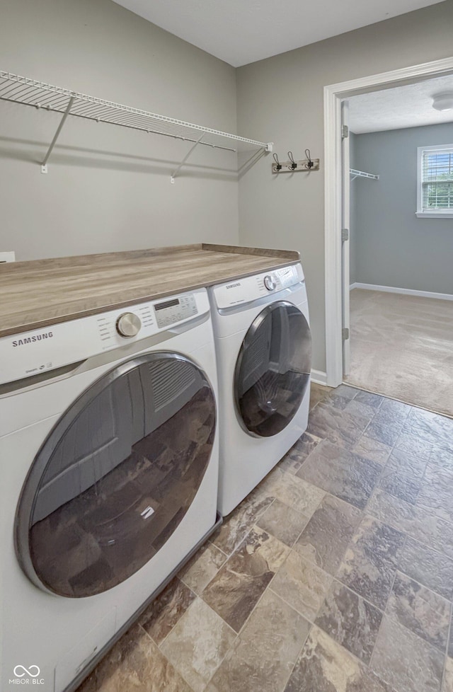 1843 Winchester Blvd, Avon, IN 46123 - laundry area featuring washer and dryer, stone finish flooring, baseboards, and carpet flooring