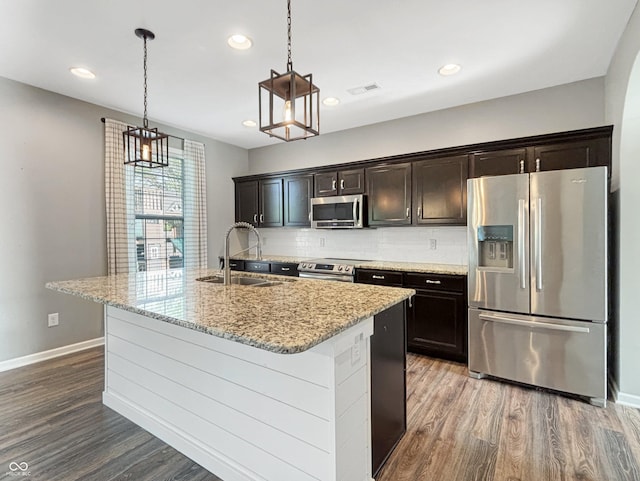 1843 Winchester Blvd, Avon, IN 46123 - kitchen featuring appliances with stainless steel finishes, a sink, wood finished floors, baseboards, and hanging light fixtures