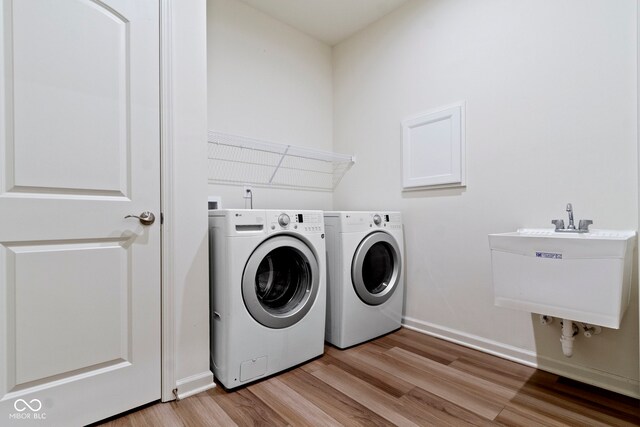 7248 Covington St, Lebanon, IN 46052 - laundry area featuring light wood-type flooring, separate washer and dryer, and baseboards