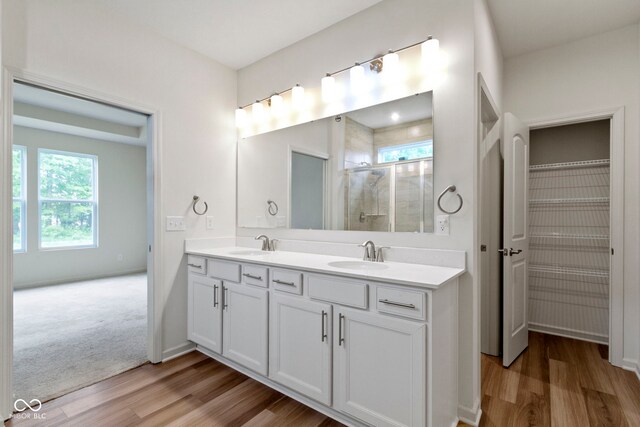 7248 Covington St, Lebanon, IN 46052 - full bath with wood finished floors, double vanity, a stall shower, and baseboards