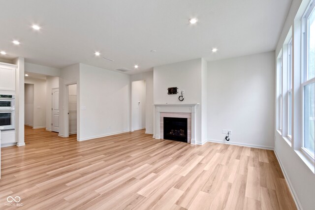 7248 Covington St, Lebanon, IN 46052 - unfurnished living room with a fireplace, light wood-style floors, recessed lighting, and baseboards