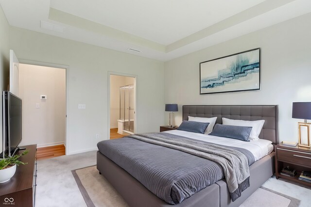 7248 Covington St, Lebanon, IN 46052 - bedroom featuring a tray ceiling, light colored carpet, connected bathroom, and baseboards