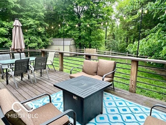 6774 S Becks Grove Rd, Freetown, IN 47235 - wooden terrace with outdoor dining space and an outdoor structure