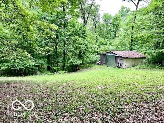 6774 S Becks Grove Rd, Freetown, IN 47235 - view of yard with a view of trees, an outbuilding, and a pole building