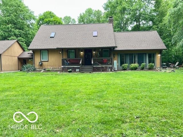 6774 S Becks Grove Rd, Freetown, IN 47235 - view of front facade featuring a porch, a front yard, a chimney, and a shingled roof