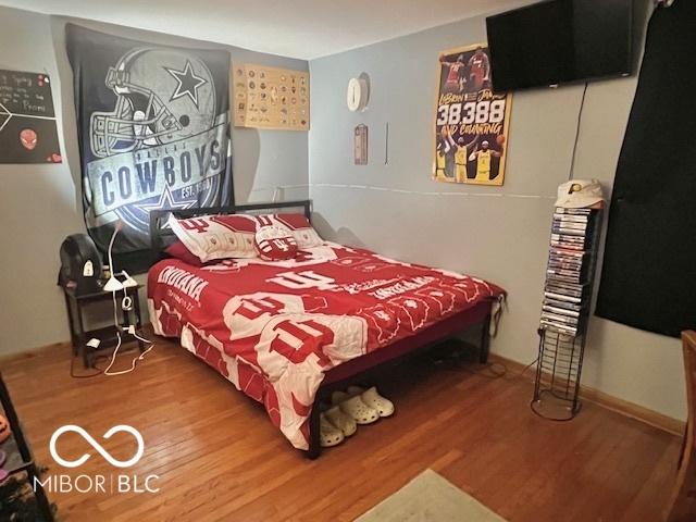 6774 S Becks Grove Rd, Freetown, IN 47235 - bedroom featuring wood finished floors